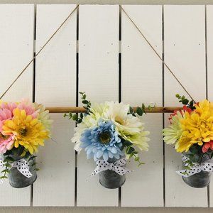 Faux gerbera daisy flower buckets.